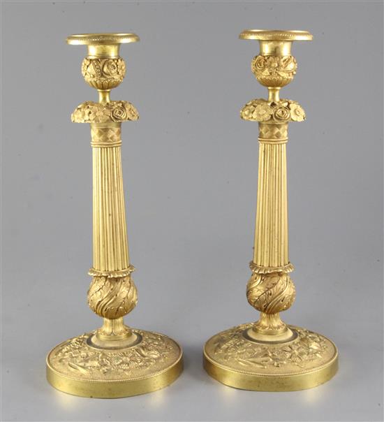 A pair of French Empire style ormolu candlesticks, height 12.25in.